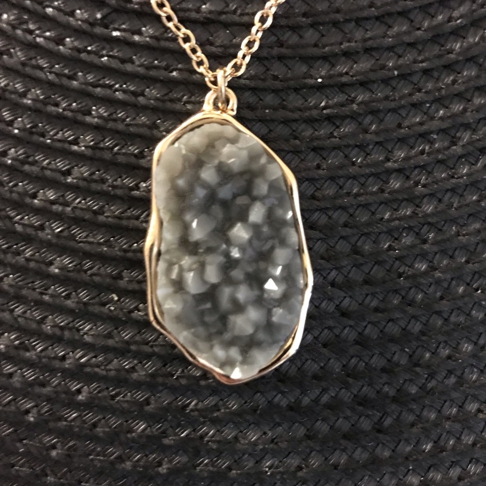 Gold chain with grey jagged stone